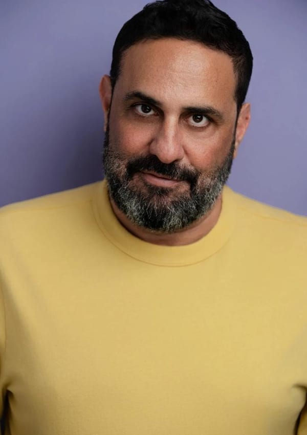 Philip Galinsky headshot yellow shirt
